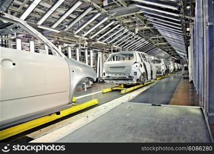 assembled cars in a row at car plant