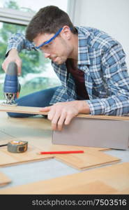 assembling furniture from chipboard using a cordless screwdriver