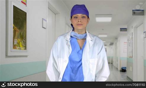Assertive medical professional crosses her arms in a hospital