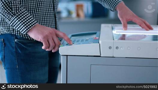 assistant makes copies of files in the copy machine