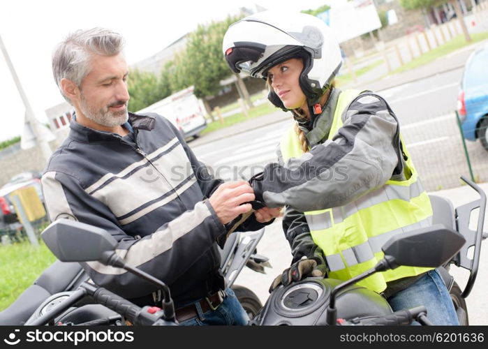 assisting in putting a motorcycle gloves