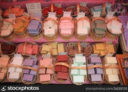 Assorted bars of soap in baskets on a market in the Provence, France