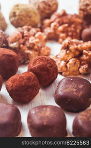 Assorted Chocolate candies on the white table. Luxury handmade sweets. The Chocolate candies