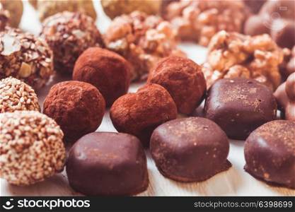 Assorted Chocolate candies on the white table. Luxury handmade sweets. The Chocolate candies