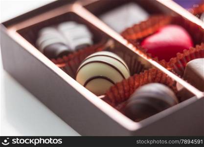 Assorted chocolates in brown box, shallow depth of field