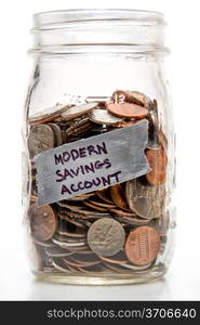 Assorted coins being saved in a mason jar.