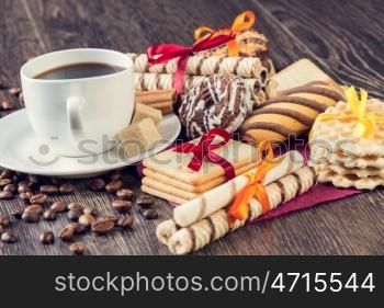 Assorted cookies and cup of coffee. Assorted cookies on table and white cup of coffee