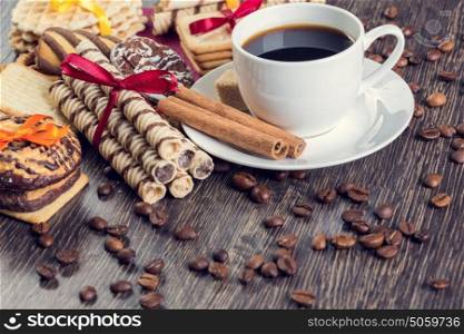 Assorted cookies and cup of coffee. Assorted cookies on table and white cup of coffee