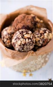 Assorted dark chocolate truffles in gift box, selective focus, close up