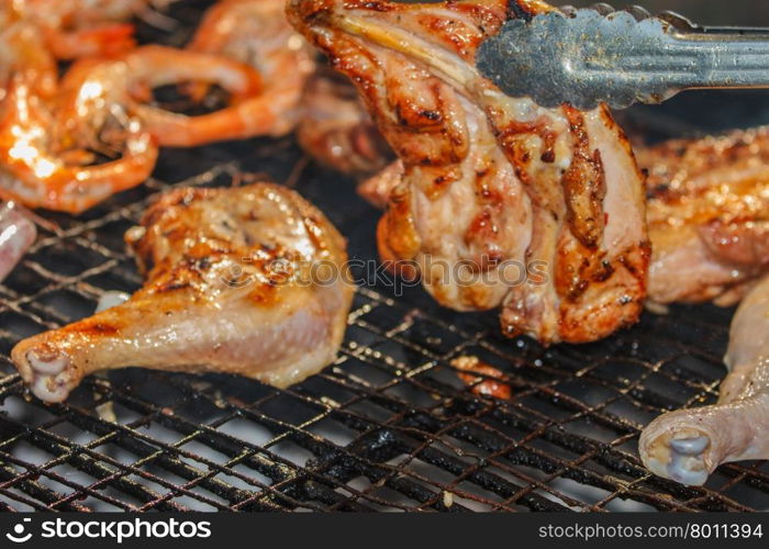 Assorted delicious grilled meat&#xA;over the coals on a barbecue