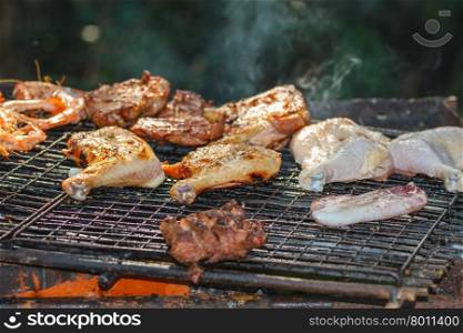 Assorted delicious grilled meat&#xA;over the coals on a barbecue