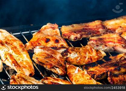 Assorted delicious tasty grilled meat with vegetables being cooked on charcoal grill