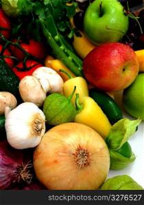 Assorted fresh fruit and vegetables with onions, garlic an tomatillos in the foreground. Vegtables And Fruit