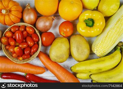 Assorted fresh ripe fruit red yellow purple and red vegetables mixed selection various ingredient food , top view / vegetables and fruits background healthy food clean eating for sale in the market
