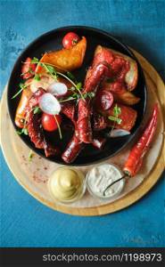 Assorted grilled sausages with mustard and horseradish