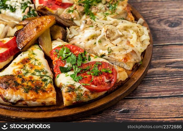 Assorted handmade Argentinian pizza on stone background