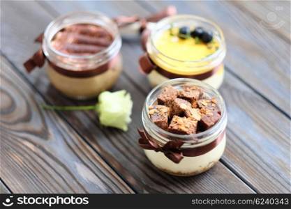 Assorted jar cakes on wooden table