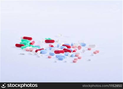 Assorted medicine pills and capsules on a light background. Healthcare concept.. Several kinds of medicine pills and capsules