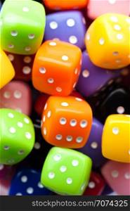 Assorted multicolor dices, close-up shot, abstract gambling background. Multicolor dices