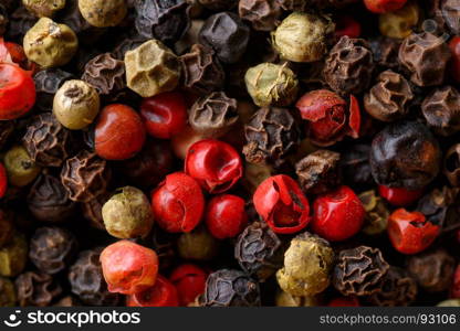 Assorted pepper corns. Backgrounds and textures: a lot of multicolored pepper corns, close-up shot, culinary abstract