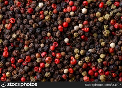 Assorted pepper corns. Backgrounds and textures: a lot of multicolored pepper corns, close-up shot, culinary abstract