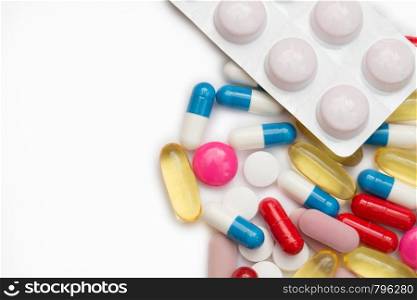 Assorted pharmaceutical medicine pills, tablets and capsules and bottle on white background. Copy space for text colorful. Assorted pharmaceutical medicine pills, tablets and capsules and bottle on white background. Copy space for text