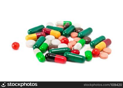 Assorted pharmaceutical medicine pills, tablets and capsules isolated on white background. Shallow depth of field. Focus on the foreground.