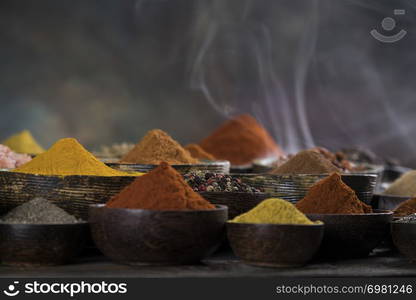 Assorted Spices and wooden bowl of smoke