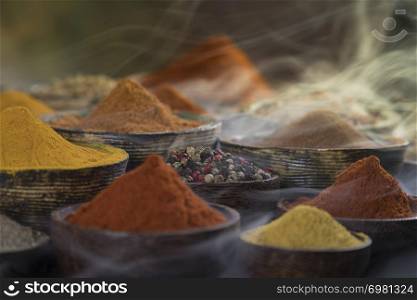 Assorted Spices and wooden bowl of smoke