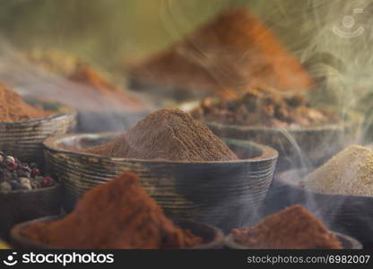 Assorted Spices and wooden bowl of smoke