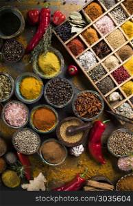 Assorted Spices in a wooden box. Variety of wooden box, spices and herbs on kitchen table