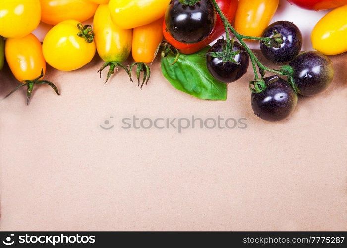 Assorted tomatoes and vegetables isolated on white background. Photo for your design