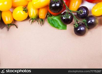 Assorted tomatoes and vegetables isolated on white background. Photo for your design