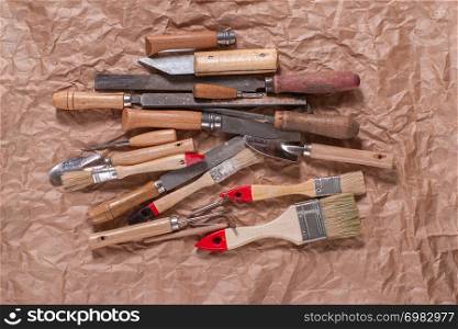 Assorted work tools on crumpled craft paper.. Assorted work tools on crumpled craft paper