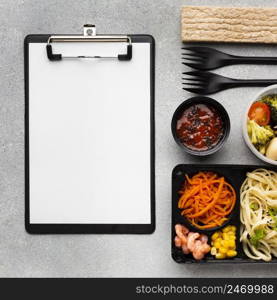 assortment different foods with empty clipboard