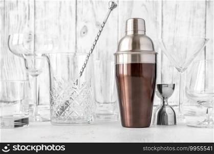 Assortment of barware and glassware on wooden background