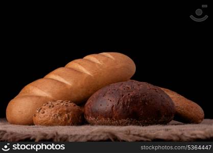 Assortment of breads still life on rustic background