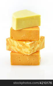 assortment of cheese blocks on a white background