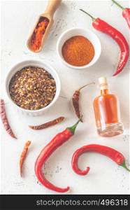 Assortment of chili pepper foods on the white wooden background