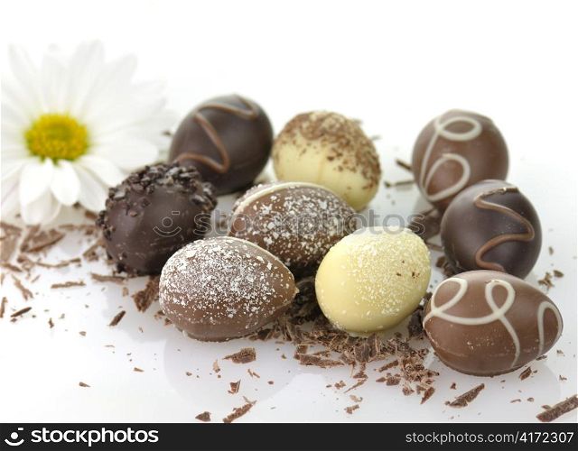 assortment of chocolate eggs on white background