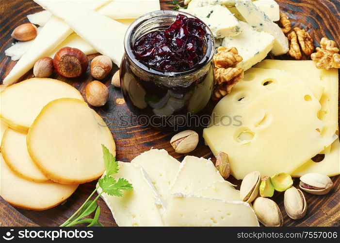 Assortment of different cheese types on plate. Cheese platter on plate