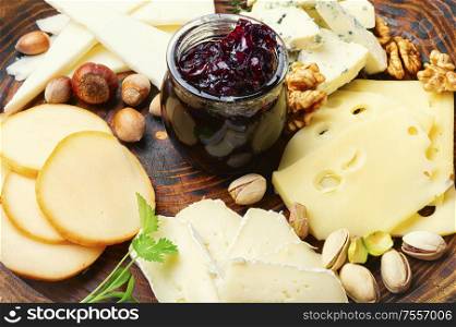 Assortment of different cheese types on plate. Cheese platter on plate