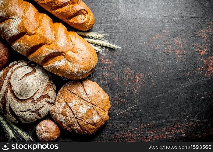 Assortment of different types of bread. On rustic background. Assortment of different types of bread.