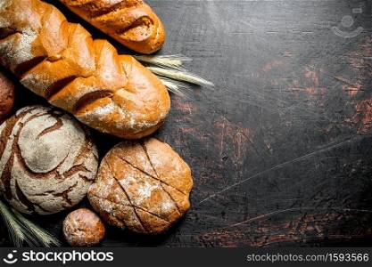 Assortment of different types of bread. On rustic background. Assortment of different types of bread.