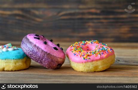 Assortment of donuts on wooden background