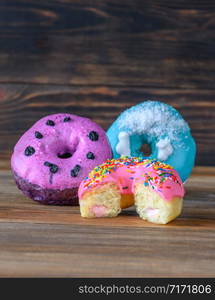 Assortment of donuts on wooden background