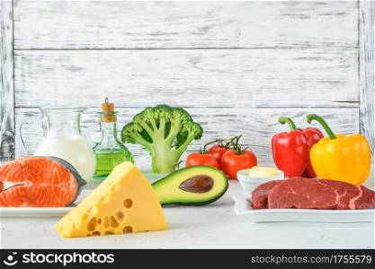 Assortment of food for ketogenic diet on wooden background