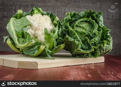 Assortment of fresh cabbages on brown background
