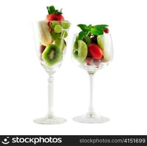 assortment of fresh fruits in a wineglass onwhite background