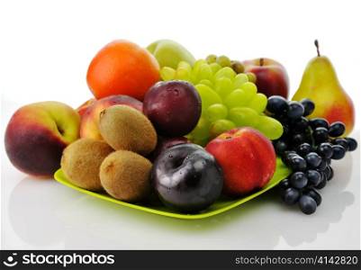 assortment of fresh fruits on a green dish
